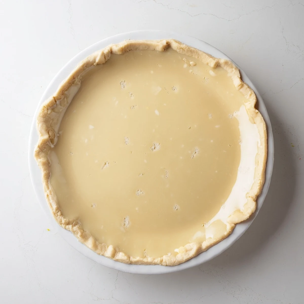 Golden, bubbly Water Pie, a light and creamy vintage dessert, ready for slicing and enjoying.