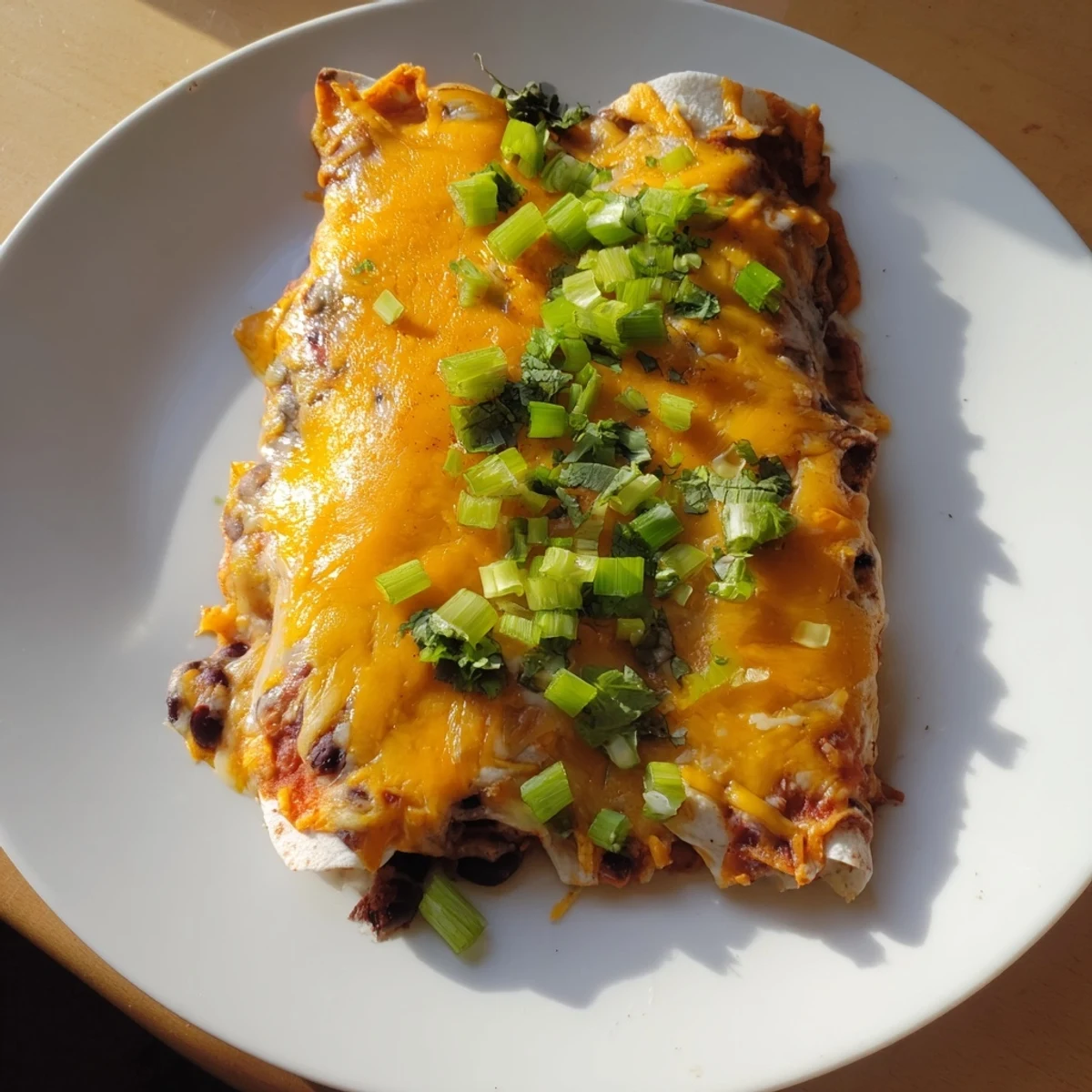 Golden and bubbly, these Cheesy Bean Enchiladas are filled with a savory bean mixture.
