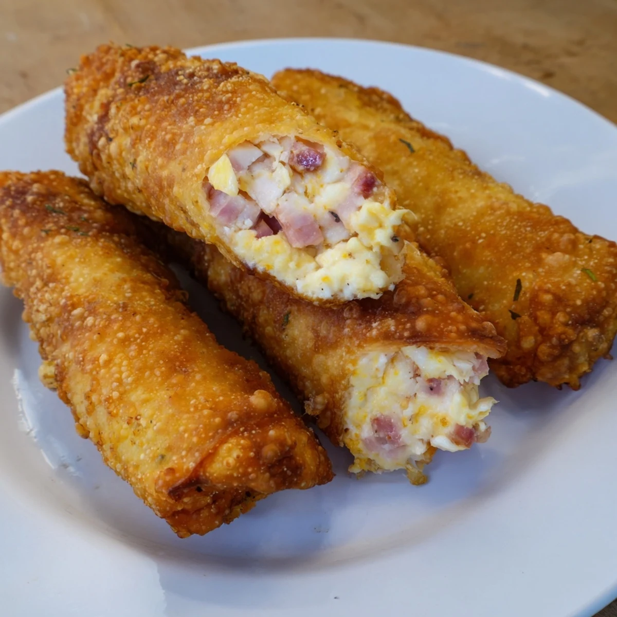 Enjoy these perfectly fried Crispy Chicken Greggs Egg Rolls, described with savory chicken and ham filling.