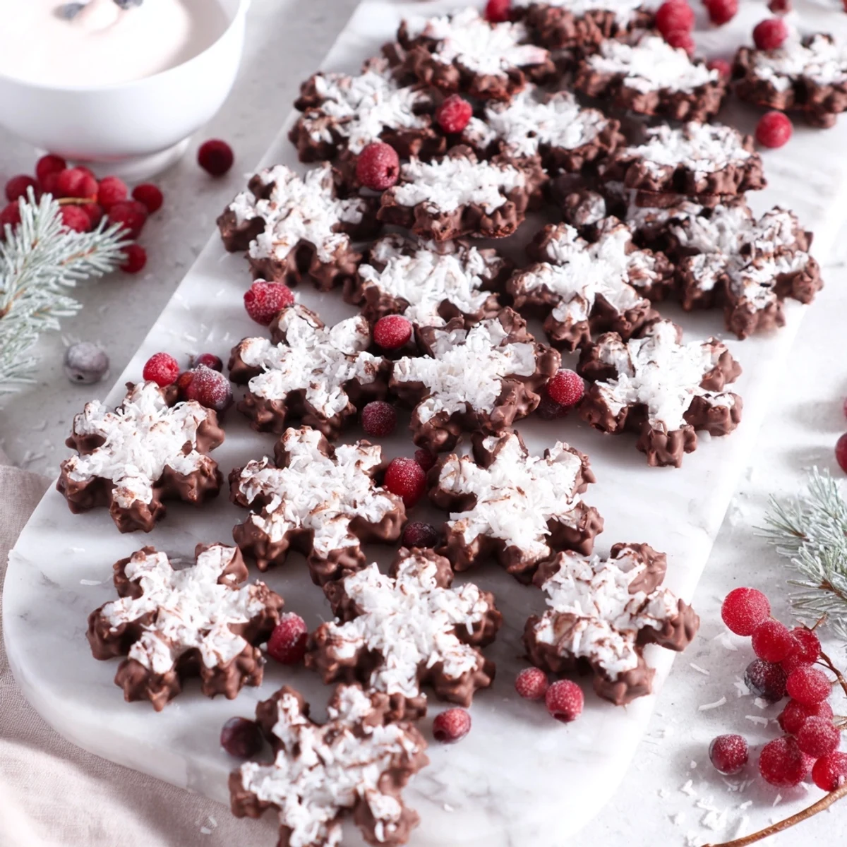 Festive Snowflake dessert board, visually stunning with white chocolates, berries, and sugared cranberries.