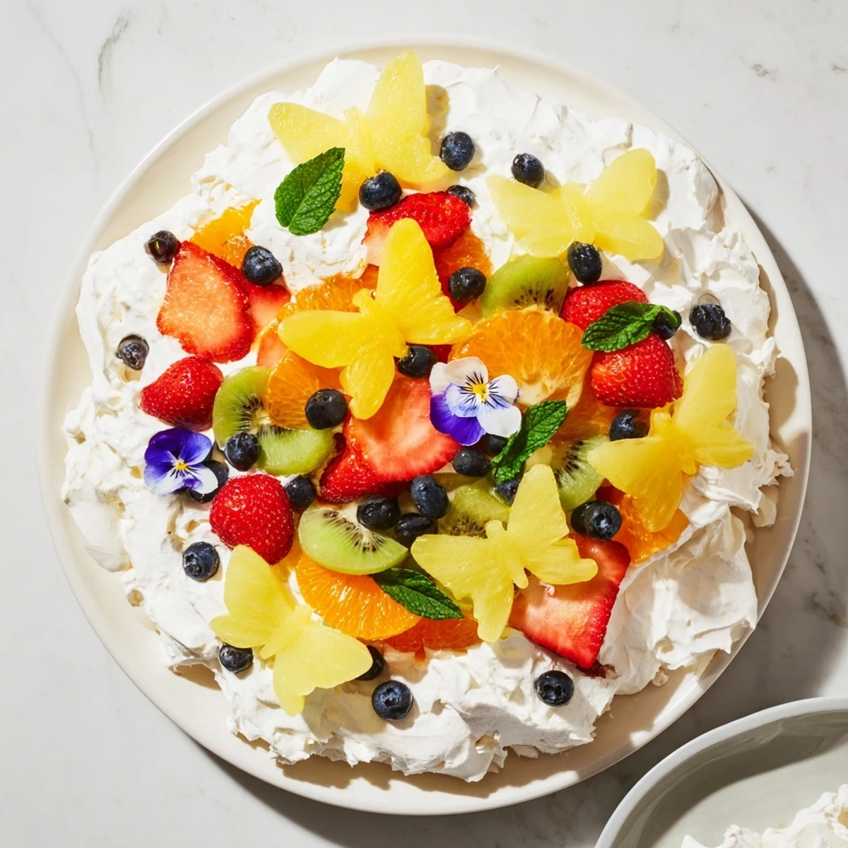 Vibrant Butterfly Fruit and Cream Cheese Board, showcasing colorful fruit arranged on fluffy cream cheese, ready to enjoy.
