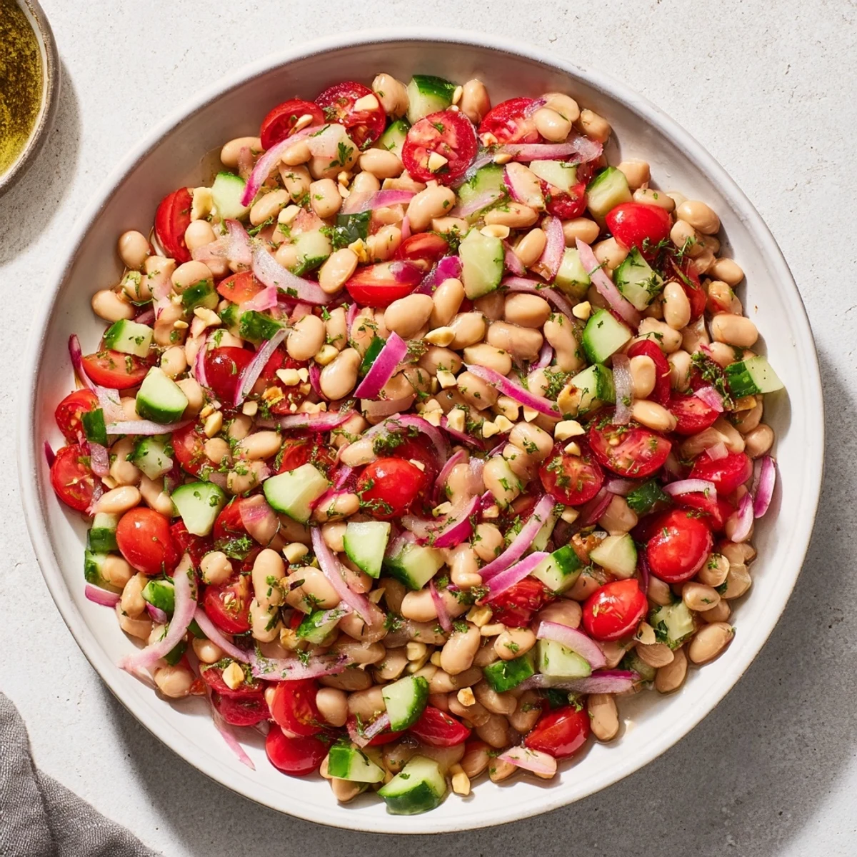 Vibrant Dense Bean Salad, tossed with tart cherry dressing, ready to eat and enjoy before bed.