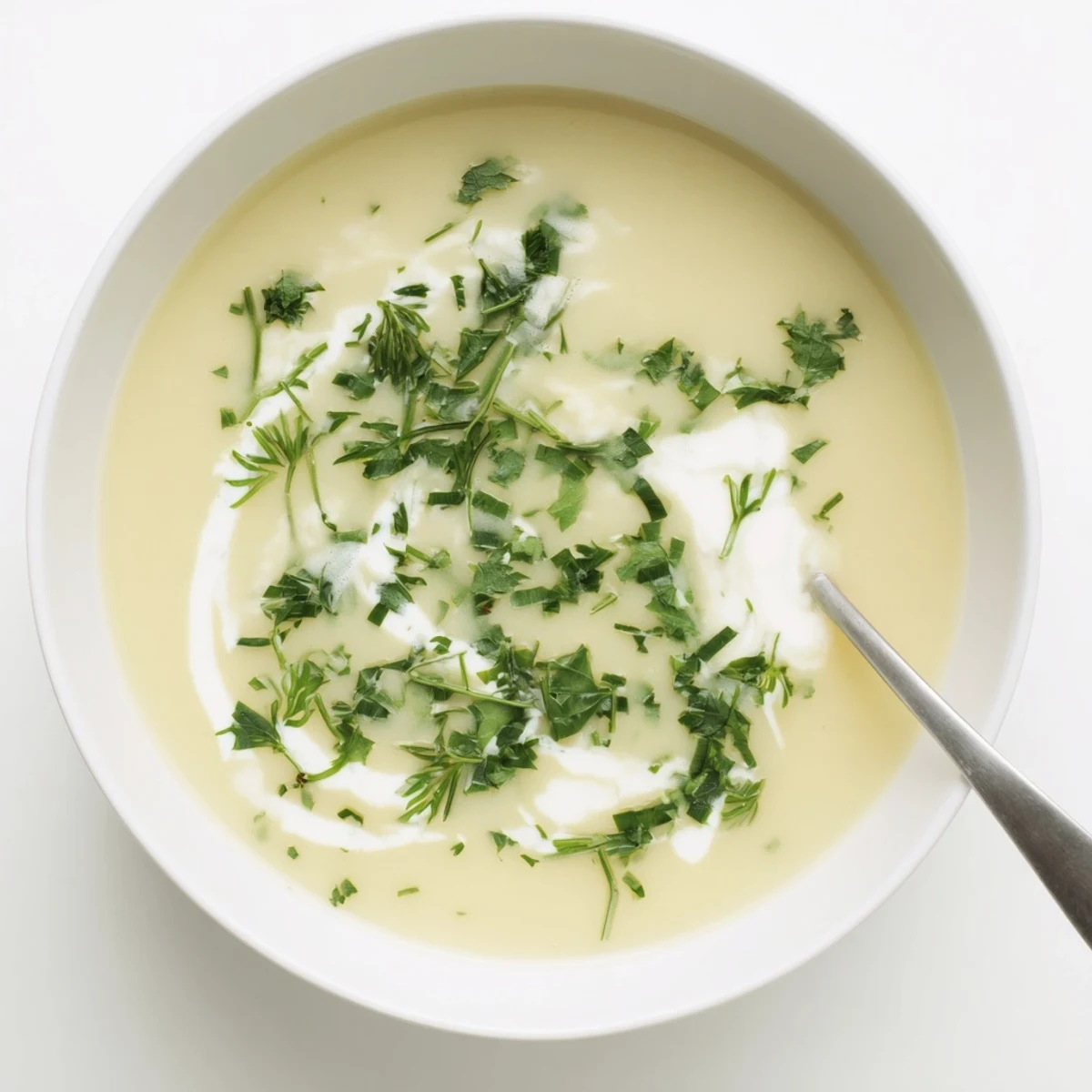 Golden roasted parsnips blended into a velvety Parsnip and Herb Soup with a drizzle of cream.  