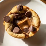 Golden-brown Air Fryer Gooey Cookie Cups, served warm, promising a delicious, gooey chocolate treat.