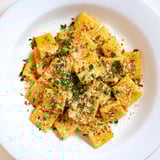 Close-up of baked Spicy Lemon-Parmesan Pasta Chips, featuring Parmesan cheese and a hint of chili spice.