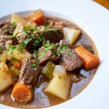 Hearty, slow-cooked Irish beef stew, showcasing chunks of beef and vibrant carrot slices.