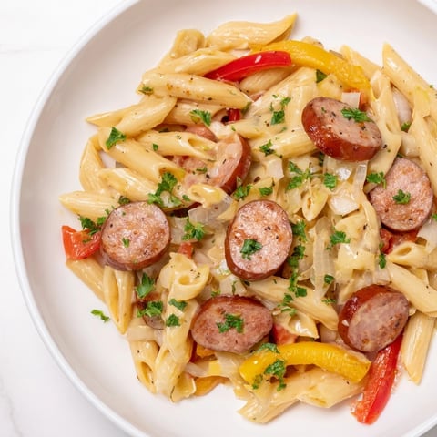 Smoked Sausage Cajun Alfredo with penne, a creamy pasta dish with smoky sausage and vibrant peppers.