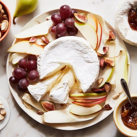 Magnificent Cheese Platter Cœur Passion: A beautiful arrangement of French cheeses and fresh fruits awaits.