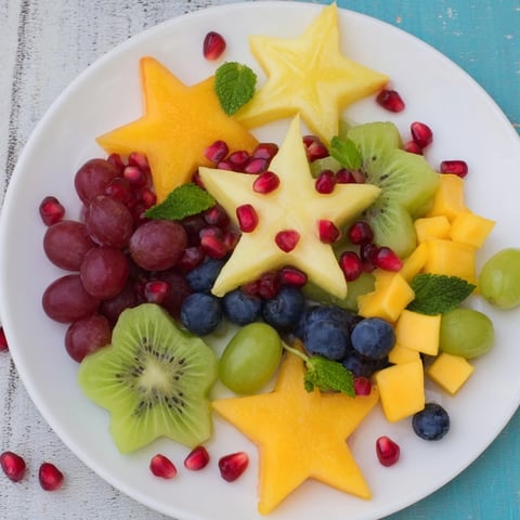 Vibrant Pomegranate and Mint Star Fruit Platter with glistening, ruby pomegranate seeds and fresh mint.