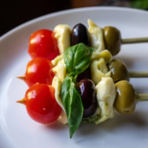 Appetizer Skewers: Tortellini, pesto, and olive skewers, a colorful Italian-inspired appetizer ready to eat.