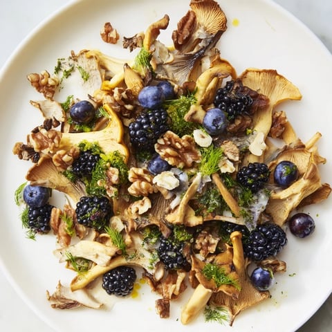 A visually appealing Northwest Forest Forager salad, featuring sautéed mushrooms, toasted nuts, and fresh berries.