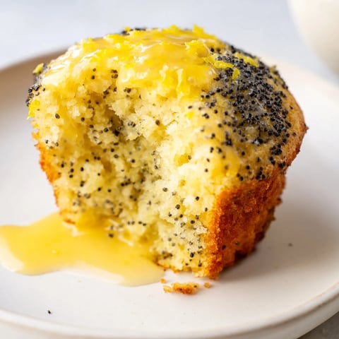 Fluffy, golden Lemon Poppy Seed Muffins, perfect for a bright breakfast alongside a cup of coffee.
