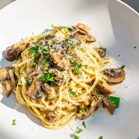 Vibrant photo of Creamy Mushroom Linguine; pasta twirled with mushrooms in a rich, creamy sauce.
