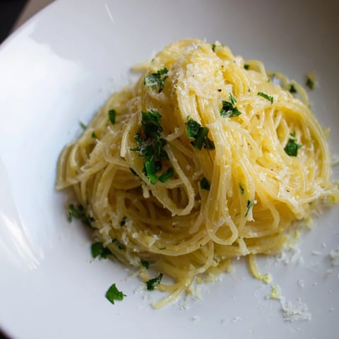 Golden strands of Lemon Butter Pasta Light are tossed in a shimmering lemon sauce, ready to eat.