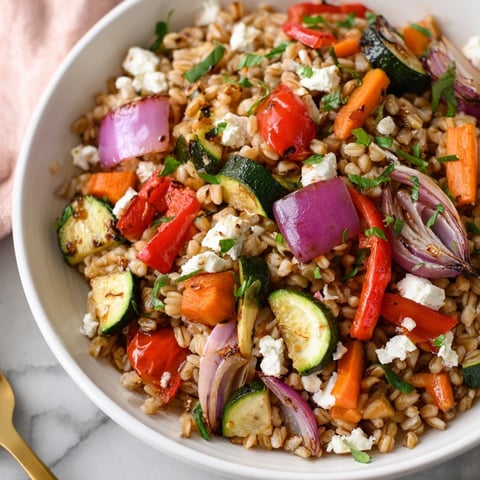 Hearty farro with roasted vegetables, a colorful, flavorful Mediterranean main dish.