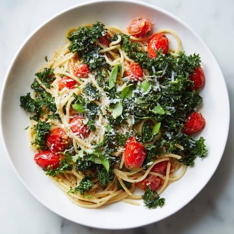 A close-up of the easy one-pot spaghetti, showing vibrant tomatoes and tender kale on the pasta.