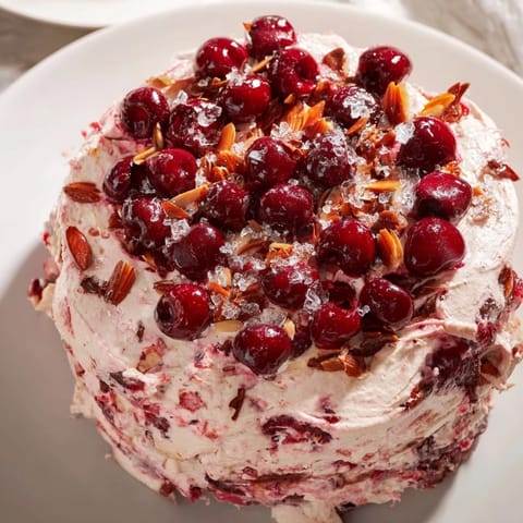 Golden Cherry Almond Loaf Cake, topped with toasted almonds, ready to slice and eat.