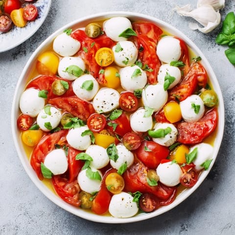 Fresh Starfish Caprese Salad with basil and balsamic glaze, a perfect summer appetizer.
