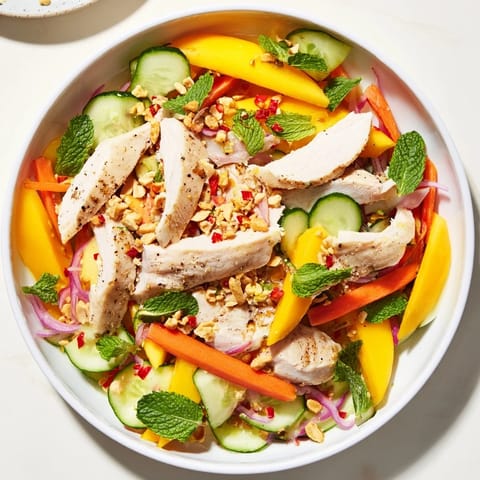 Freshly tossed Thai Mango Chicken Salad, featuring tender chicken, crunchy vegetables, and a zesty lime dressing.