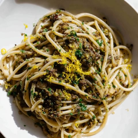 Freshly made Olive Tapenade Pasta, speckled with capers, a vibrant and flavorful vegetarian dinner.
