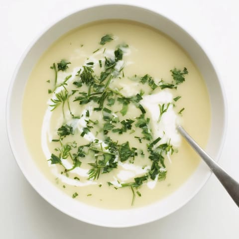 Golden roasted parsnips blended into a velvety Parsnip and Herb Soup with a drizzle of cream.  