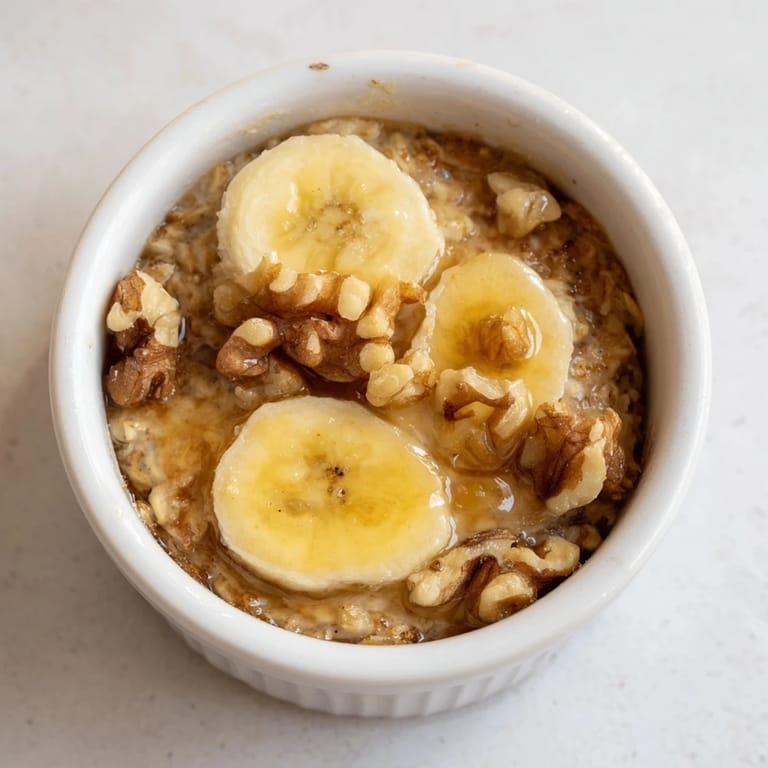 Enjoy the delicious aroma of baked oats ramekins recipe, with a topping of fresh banana slices.